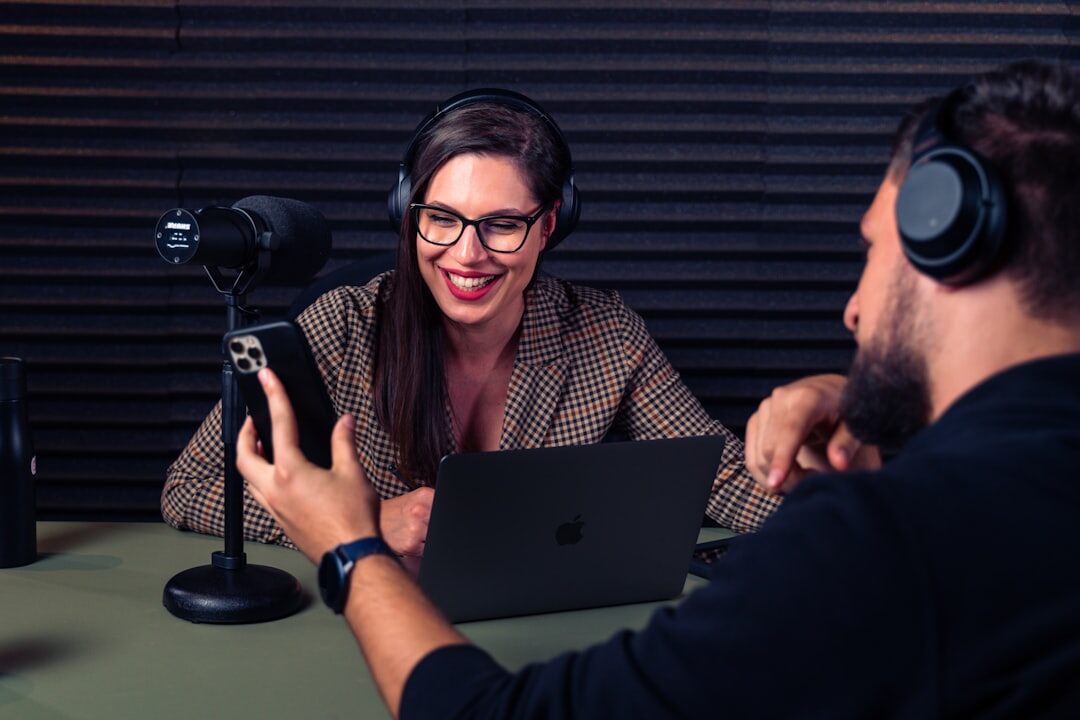 Person recording a podcast with microphone and headphones in a studio