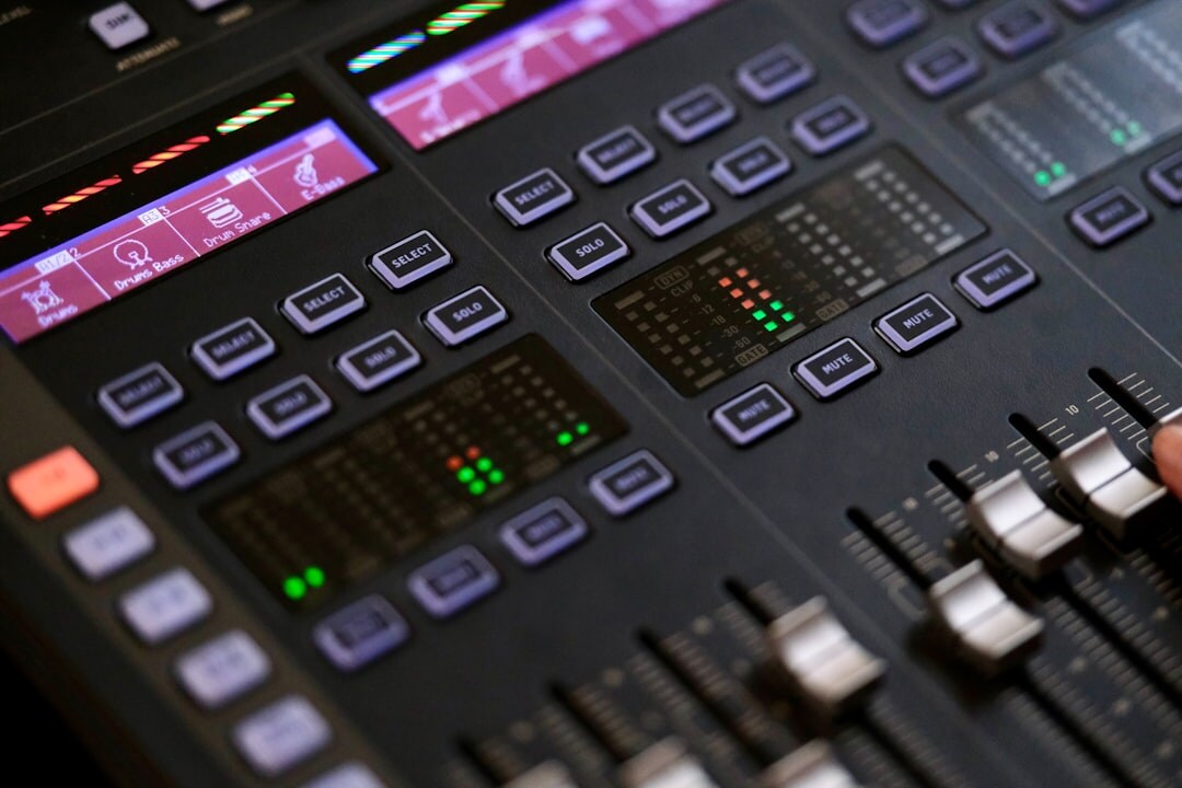Sound engineer at mixing board in professional recording studio