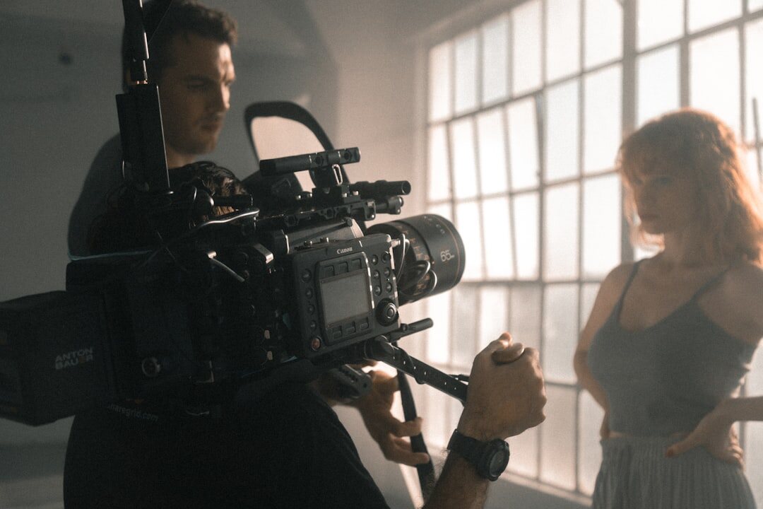 Cameraman operating a professional video camera on a film set
